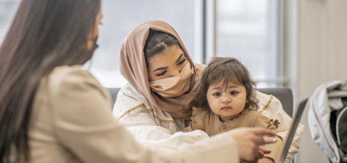 A mother and daughter going into a country to seek asylum