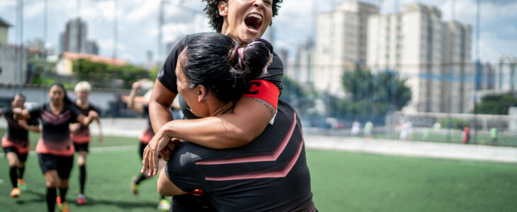 Female soccer team celebrating