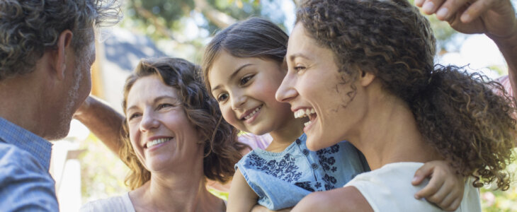 Family hugging outdoors